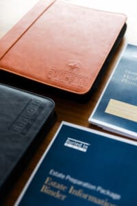 Image of buried in work notebooks and documents