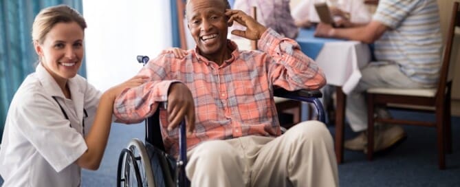 Portrait of cheerful disabled senior man sitting on wheelchair