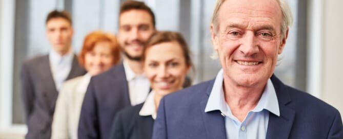 Image of multiple generations of people standing behind each other