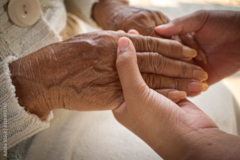 Young hands holding older hands