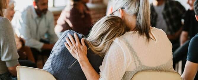 People support each other in a rehab session