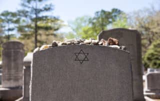 Headstone in Jewish Cemetery with Star of David and Memory Stones