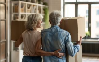 Elderly couple of new home with moving boxes. Retirement, relocation, and starting a new life beginnings.