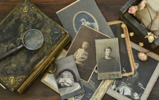 Still-life with old photo album and historical photos of family