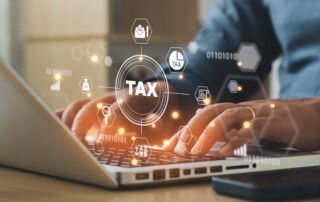Someone using a computer that says taxes.