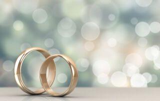 A pair of gold wedding rings with bokeh background