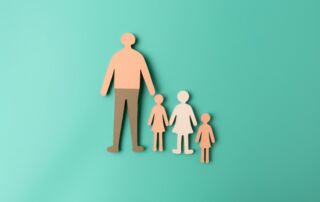 Paper family cutout on a pastel background. Life insurance, health insurance, travel insurance and family protection concept.
