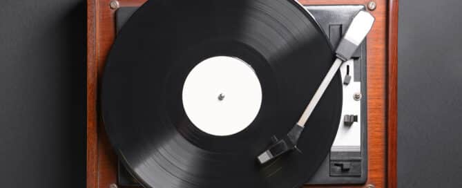 Record player with vinyl disc on dark background